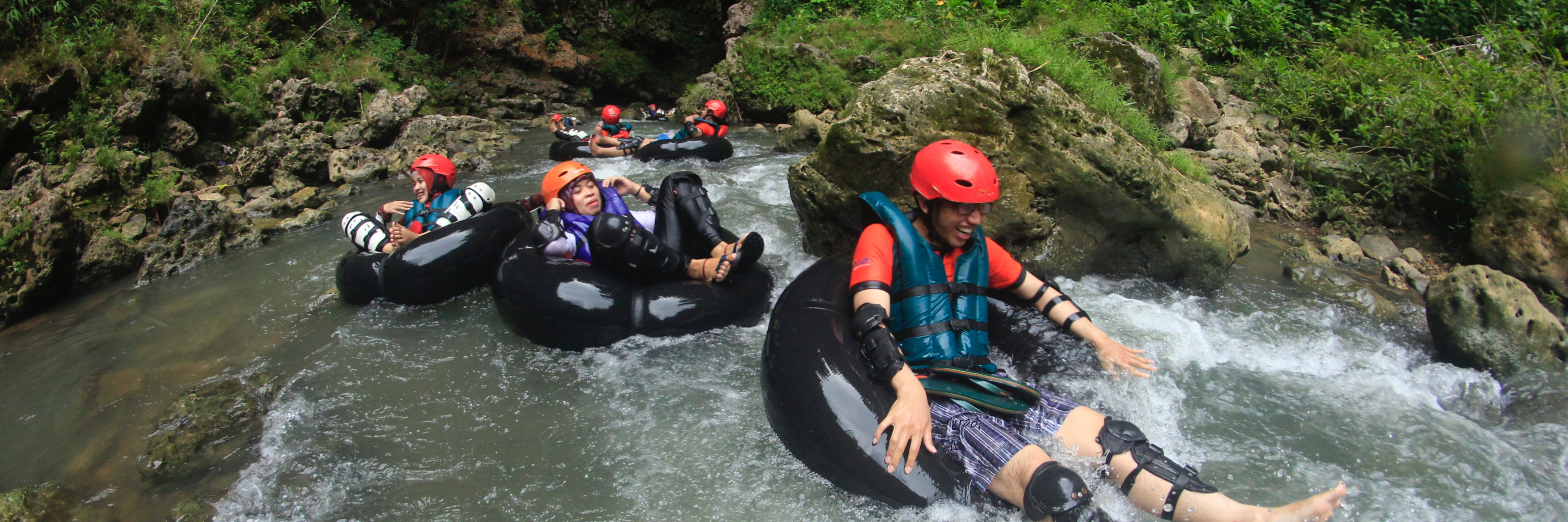 People tubing down a river